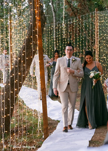 Couple walking bridal aisle.