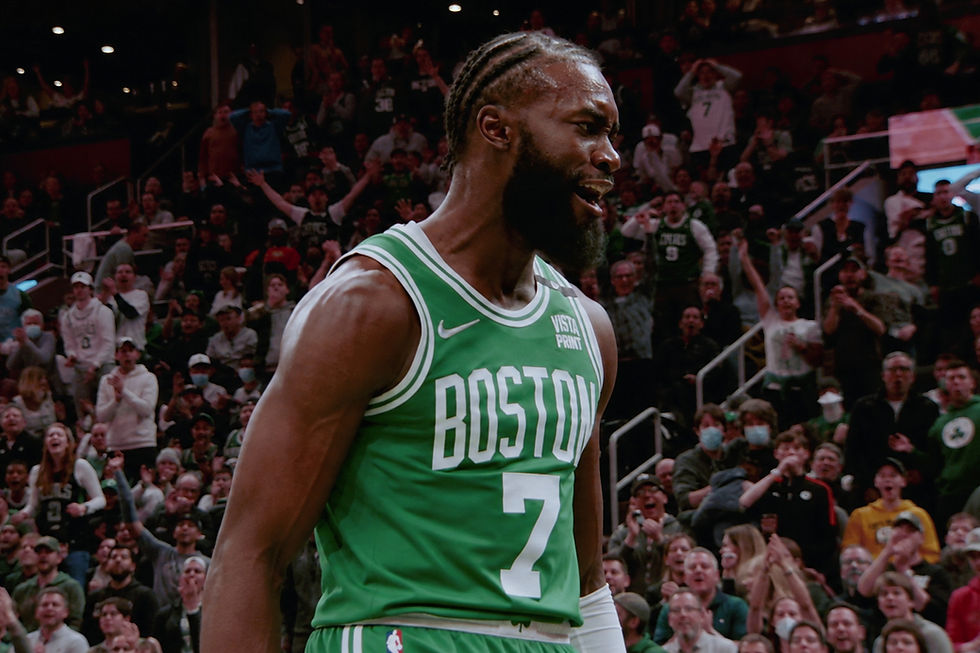 Pass the Rock — Jaylen Brown in a green Boston Celtics jersey stands courtside before a cheering crowd.