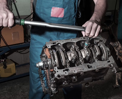 mechanic-with-wrench-disassembles-car-engine-work-garage.jpg