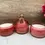 Thumbnail: Vintage Princess Glass cranberry triple candy dish filled with premium all natural scented soy candles by Decor and Wicks candle shop.