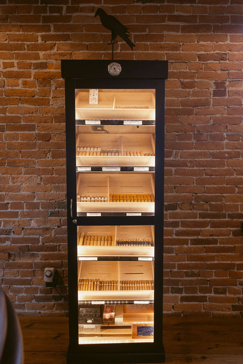 "Humidor cabinet storing premium cigars at The Booking House."