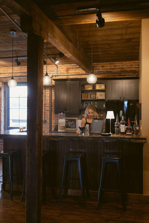 "Custom bar in the crow's nest with bar tender at The Booking House."