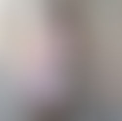 Model posing a a doll in a pink dress