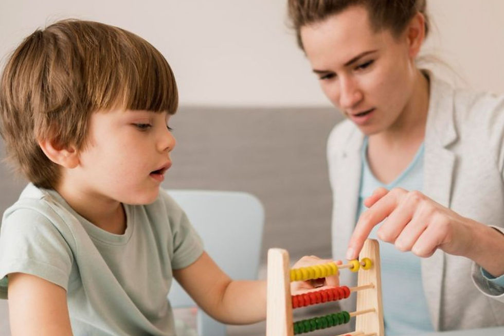 ABA therapist supporting a child with a learning activity using an abacus