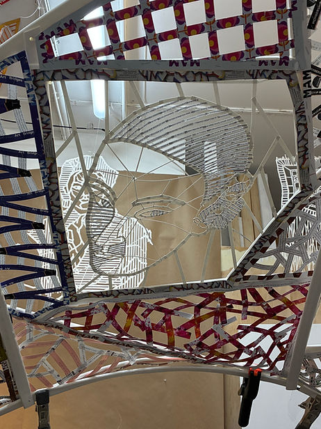 A resident of Orange, NJ, Kate Dodd (b. 1960) is well known for her many public art commissions throughout the Garden State and elsewhere. You're Invited is an immersive site-specific installation in the Laurie Art Stairway, made primarily of excess printed Montclair Art Museum materials, that fully engages viewers in a sculptural experience that they can walk through. Conceptually, the work invites the viewer to contemplate the role of museums as stewards of art. By using repurposed materials, Dodd also encourages visitors to think about waste, environmental degradation, and our consumer culture.
The installation is constructed from thousands of paper strips assembled into a web of quilt-like patterns draped over an arched structure, which encloses the length of the stairway and then curves upwards again to spread across multiple windows. By emphasizing the stairs’ processional flow, the abundance of light, the transparency of the enclosure, and the monumental scale of the interior, the architectural attributes of the Museum’s extension are fully celebrated.