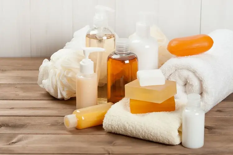 A collection of personal care products including shampoo, soap, lotions, and creams arranged neatly on a shelf.