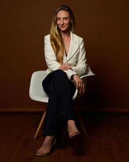 woman in white suit jacket posing for power portrait