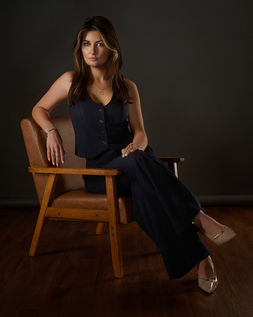 confident real estate agent posed sitting in armchair for business portrait