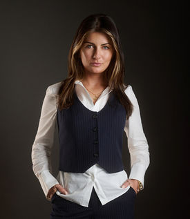 Teide Grice posing for power portrait in in smart vest and white blouse