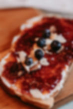 Toast with jam, blueberries, and almond slivers