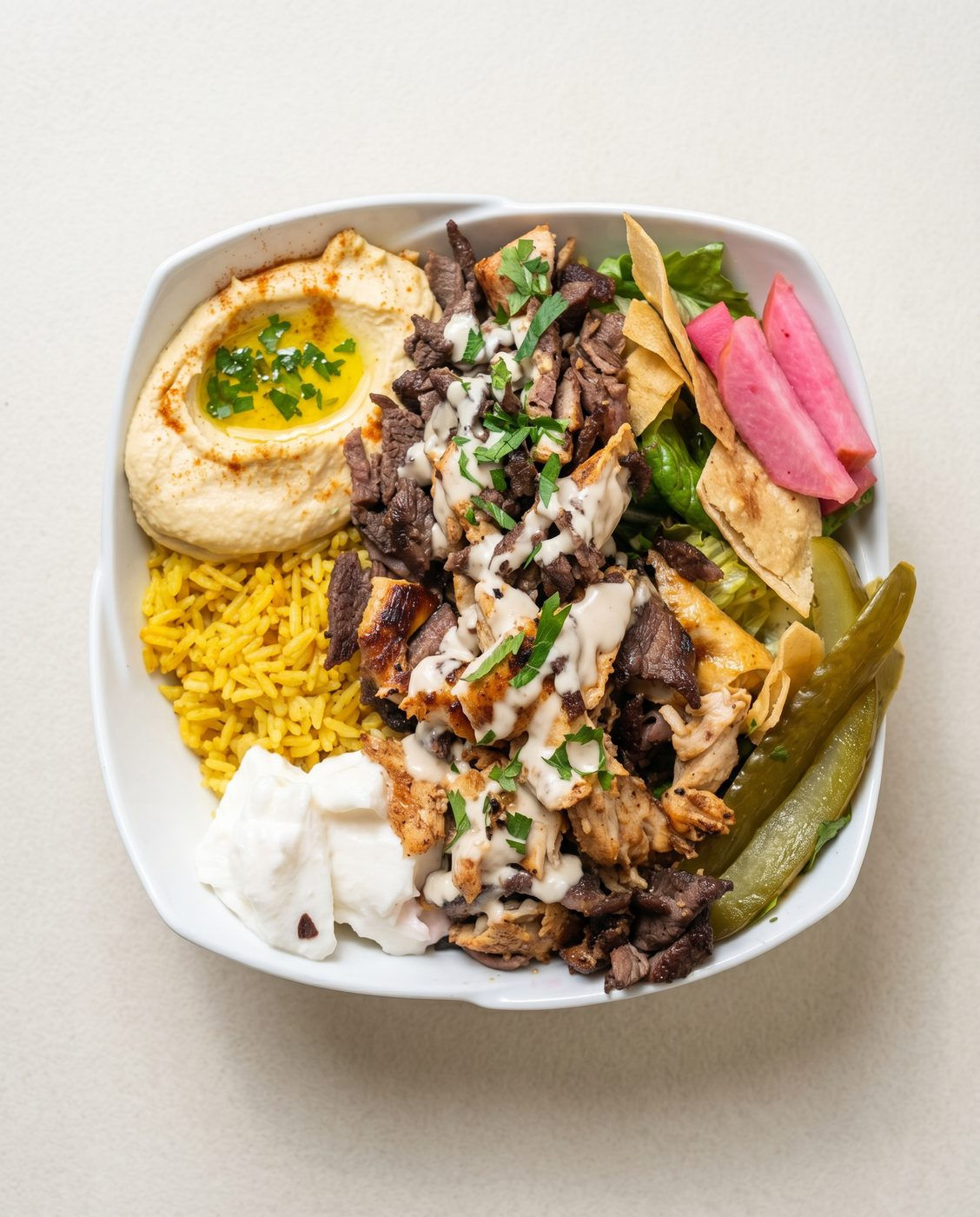 Best mix shawarma bowl in Windsor Ontario — overhead mixed chicken and beef shawarma bowl on a white plate at Aromas Cafe by 7Spices