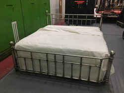 Steel bed on castors