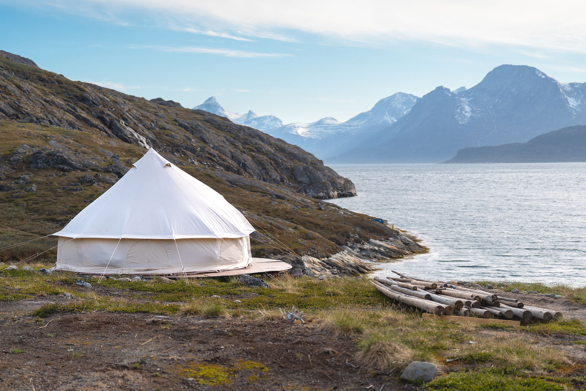 Mountain landscape rising above the blue waters of Nuuk Fjord near Camp Kiattua, Greenland.