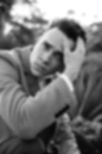 professional model photography brisbane: black and white headshot of male modeling a coat