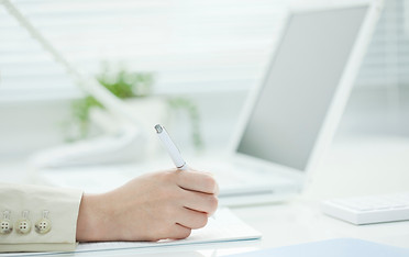 書類に文字を書く人