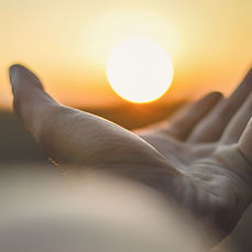 Close up of Reiki hand looking like it's holding the sun