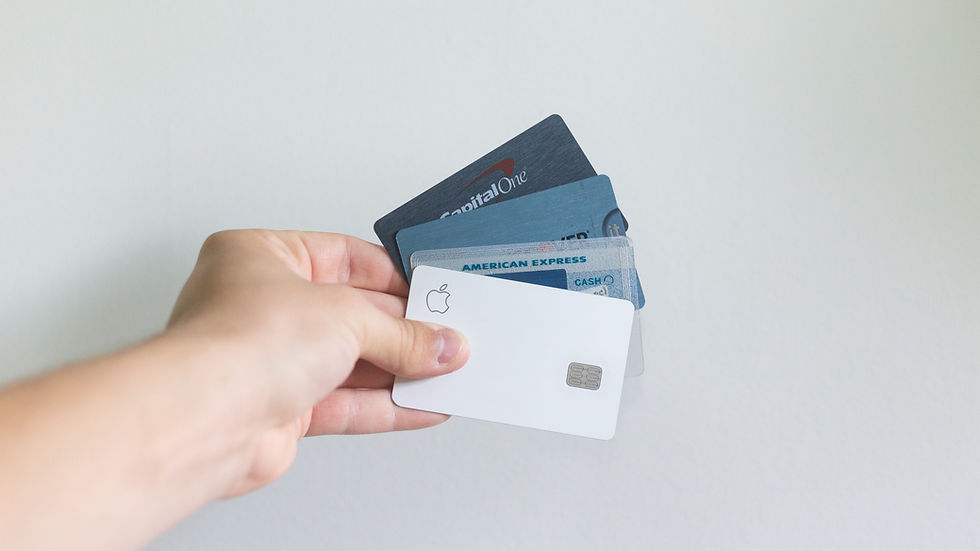 Person holding various credit cards.