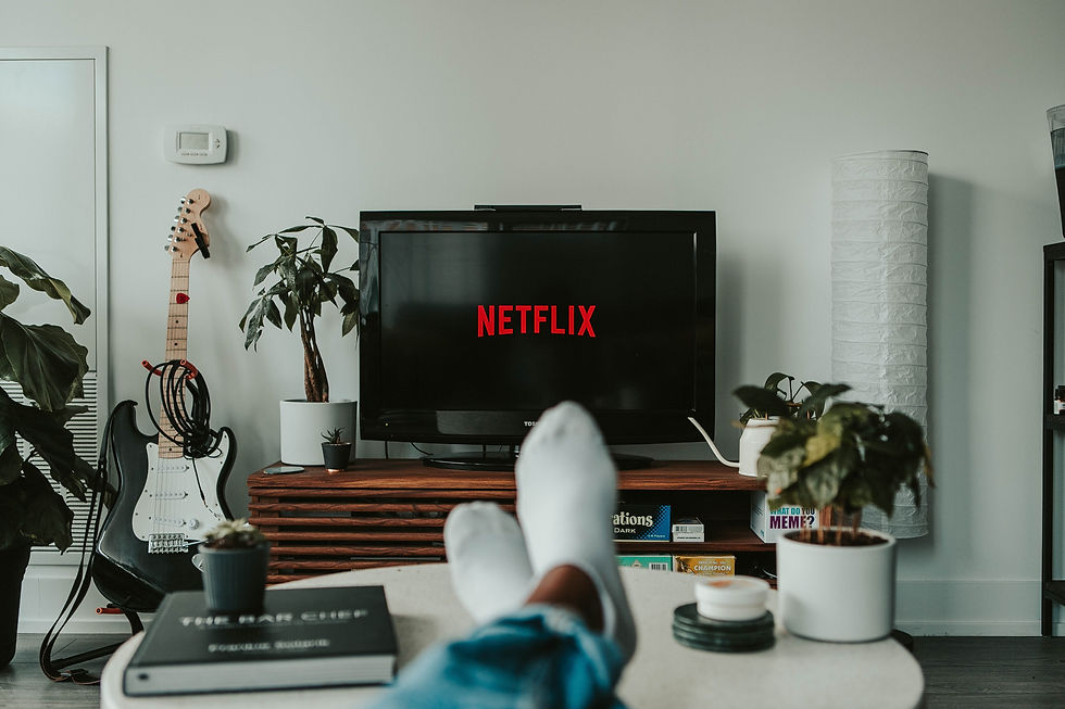 Someone sitting on a couch watching Netflix.