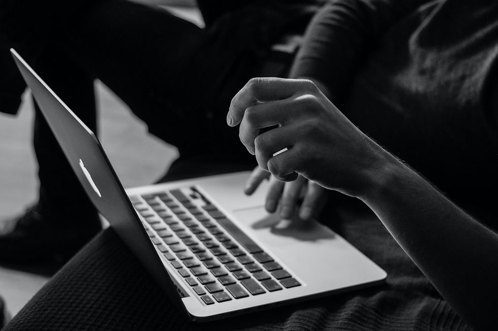 Person writing on laptop.