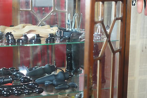 Antique cabinet filled with BDSM toys and fetish gear in a Lisbon Dominatrix studio