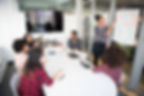 Women sitting around conference table