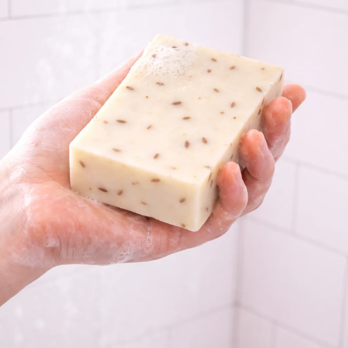 Lavanda Flor Bar Soap — single bar shown in use