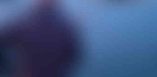 Crew member observing conditions from aft deck during offshore passage northbound