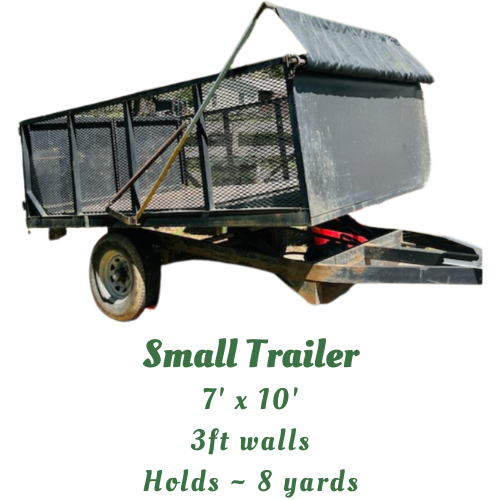 Wide angle view of an 8 cubic yard rental dump trailer filled with furniture and yard waste