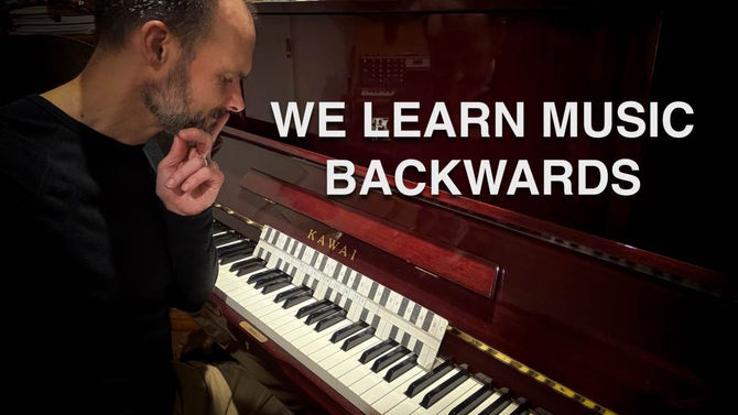 Mat Creedon sitting thoughtfully beside a piano with The Easy Key displayed across the keyboard and the words “We Learn Music Backwards” overlaid on the image.