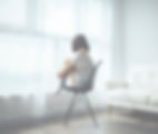 woman sitting on black chair in front of glass-panel window with white curtains_edited_edi
