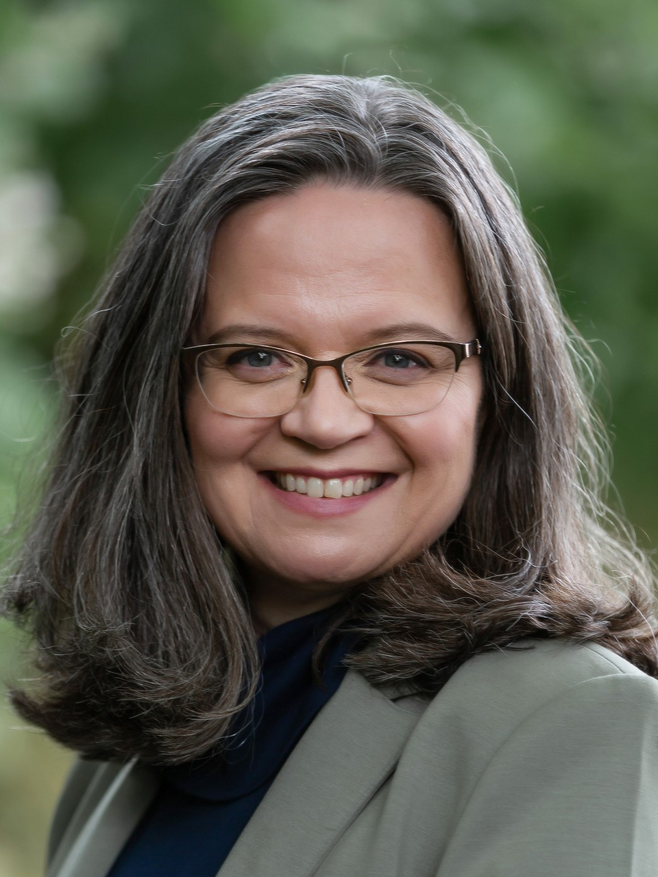 Jamie Morin, attorney, woman smiling wearing a gray blazer