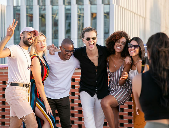 A lively group of friends arm-in-arm, laughing and posing for a celebratory cocktail workshop photo in Toronto. The image captures the joy and camaraderie of a unique team-building activity, perfect for corporate events, birthday parties, and special occasions. The smiling participants showcase the fun and interactive nature of the mixology experience, where guests learn to craft signature cocktails under the guidance of skilled bartenders. Colorful cocktail ingredients are arranged on the bar, setting the stage for a memorable experience that fosters bonding and creativity. This image embodies the excitement and energy of an unforgettable celebration cocktail workshop in Toronto, designed to elevate any gathering with a touch of sophistication and a lot of fun. celebration cocktail workshop for special occasions, interactive mixology classes for birthdays and parties, unique Toronto events for group celebrations, hands-on cocktail-making experiences for friends, hire skilled bartender