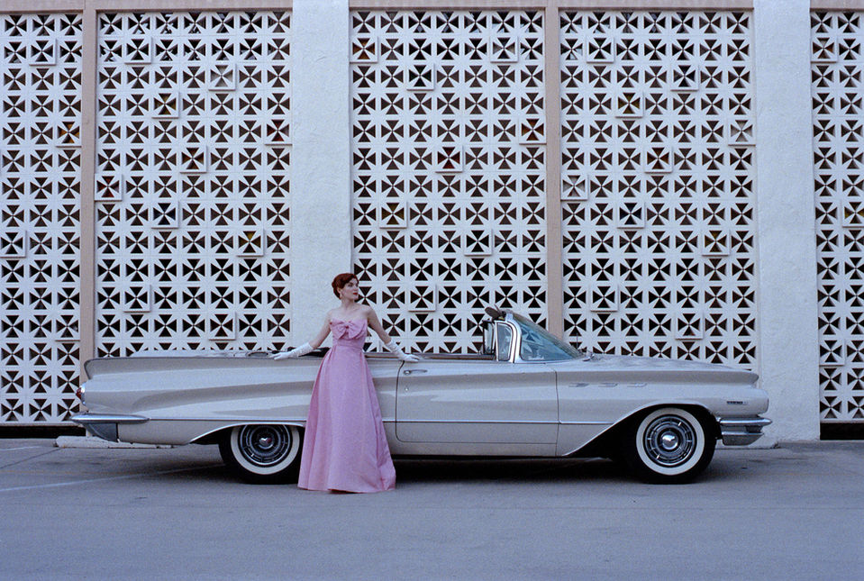 1959 Buick and a model in a pink dress in front of a Mid Century breeze-block wall, an editorial style photo by Fabian Fioto in Southern California