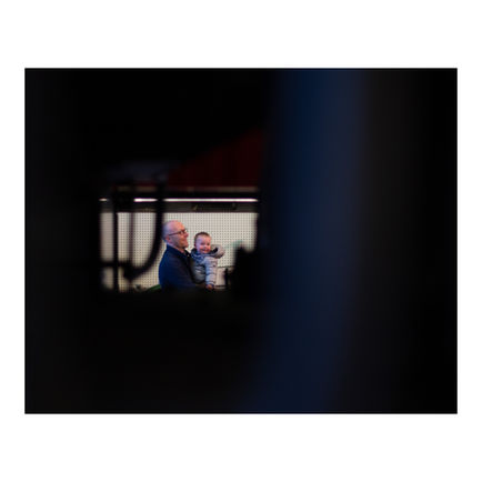 Father and Baby Through Train Undercarriage