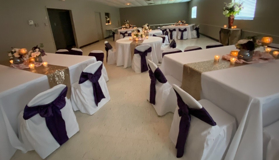 Dining hall filled with decorated tables and chairs for an fancy event
