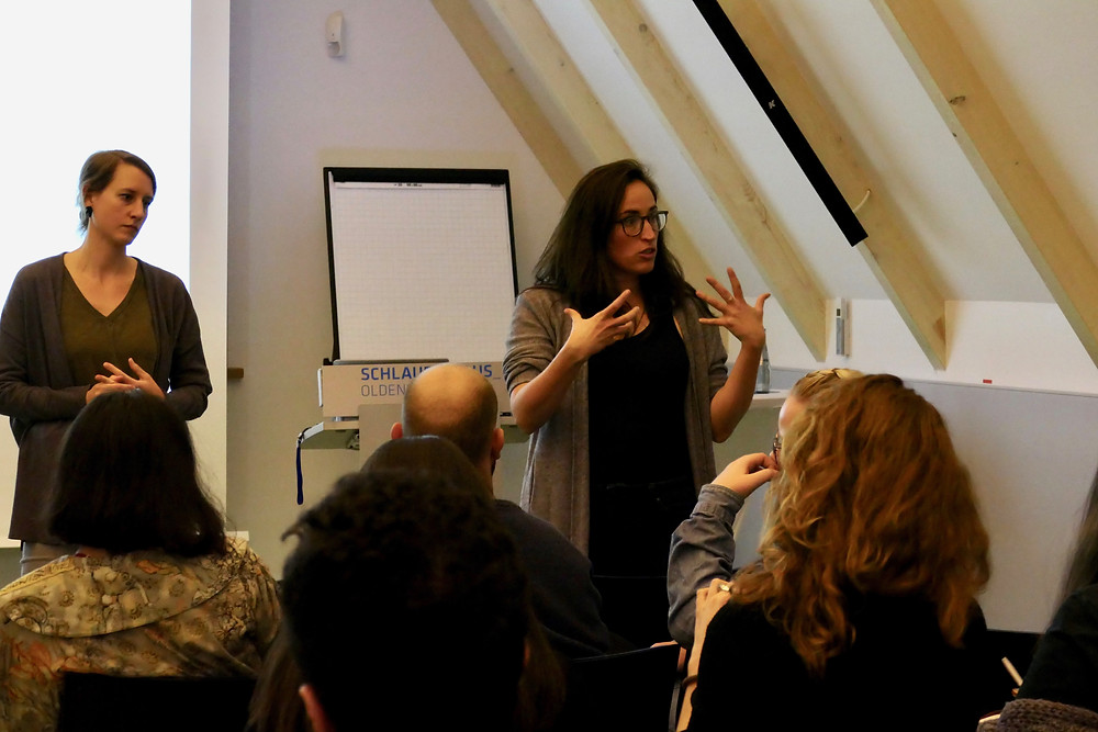 Kelly Miller and Sophia Burton from MigrationMatters speaking to an audience of EMMIR students and civil society in Oldenburg, Germany.
