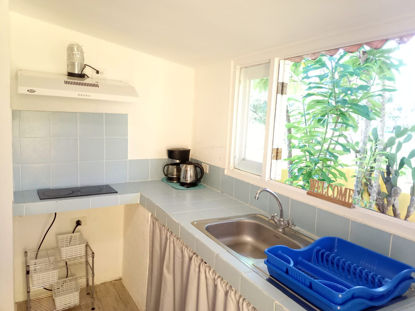 Comfortable studio-style rental unit with bed and sitting area at Villa del Sol income property