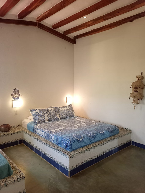 Comfortable studio-style rental unit with bed and sitting area at Villas del Sol income property