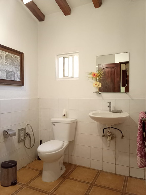Bright apartment with double bed, seating area and ceiling fan at Villas del Sol