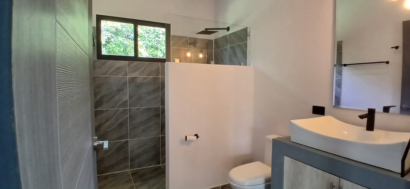Modern walk-in shower in newly constructed home in Equus Village, Pedasí.