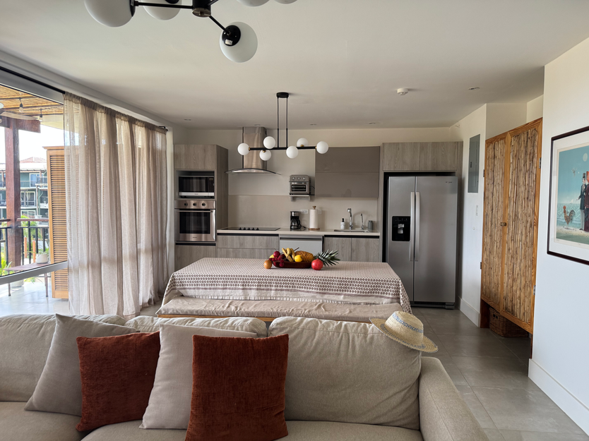 "Open-concept kitchen and living room with modern finishes inside a Blue Venao oceanfront condo."