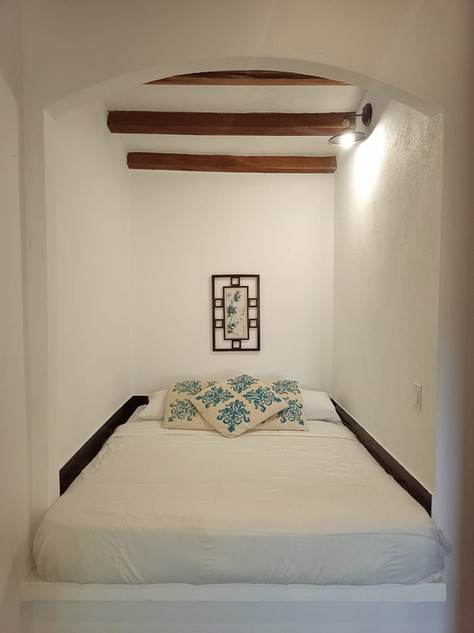 Comfortable studio-style rental unit with bed and sitting area at Villa del Sol income property