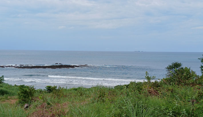 Wide view of wild undeveloped beach and tropical coastline at Playa Chumico, Pedasí.