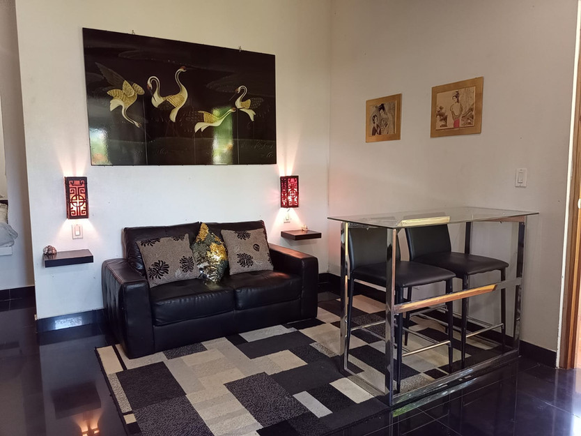 Comfortable studio-style rental unit with bed and sitting area at Villa del Sol income property