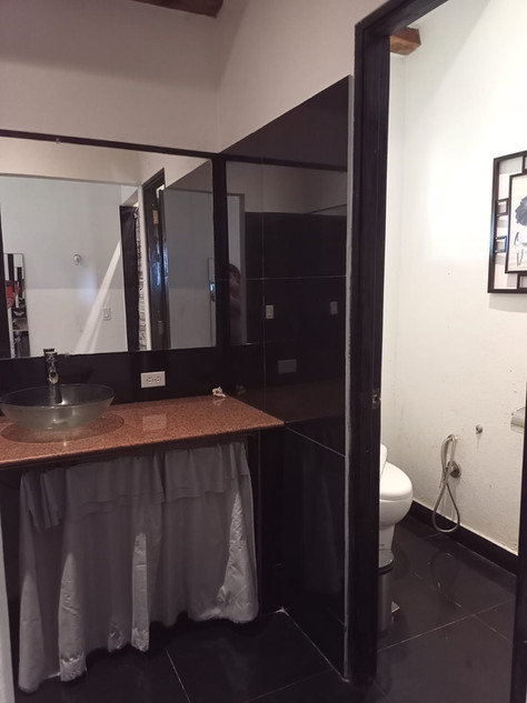 Comfortable studio-style rental unit with bed and sitting area at Villa del Sol income property