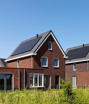 Solar panels on the roof of new built houses in The Netherlands collecting green energy fr