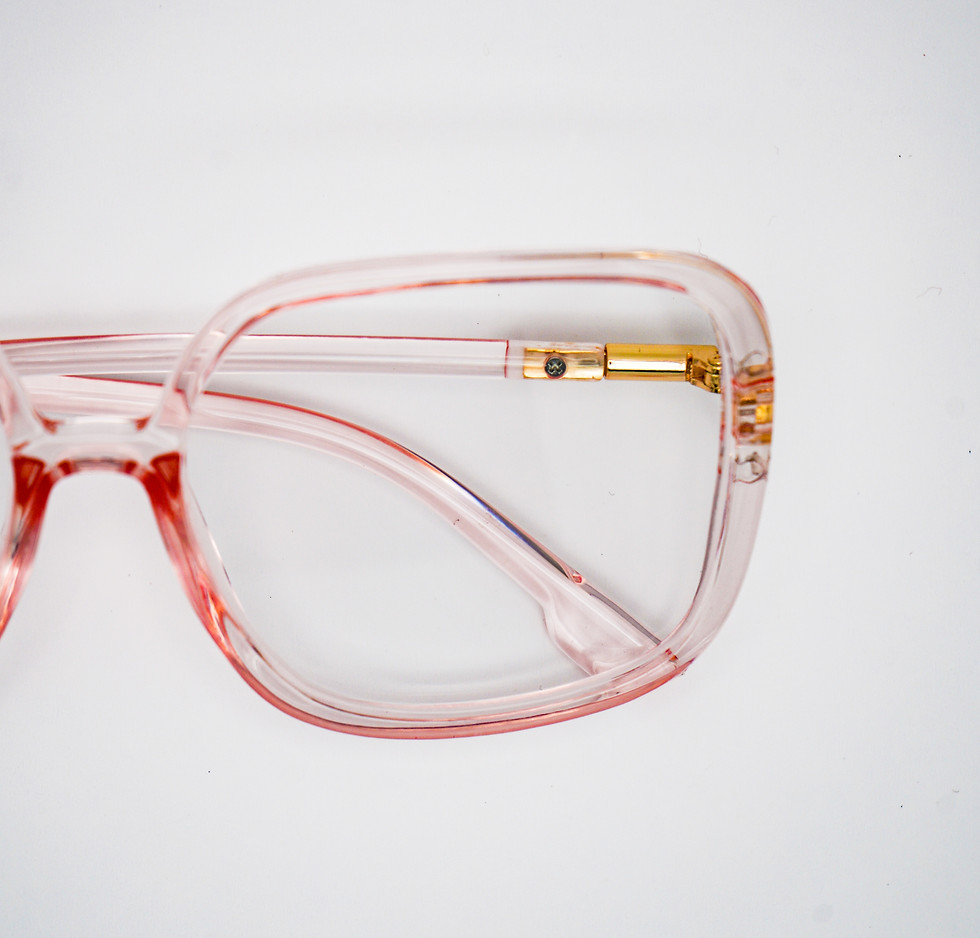 Close up on lens of Soft blush clear lens sunglasses with gold details, elegant statement eyewear.