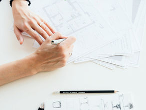Hands working on remodeling budget.