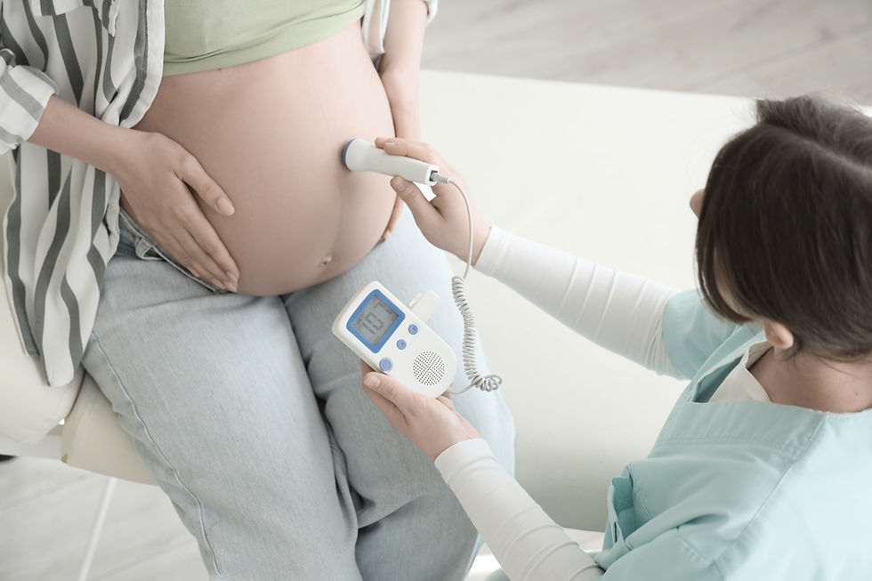 Female doctor with fetal doppler listening to baby's heartbeat in clinic.jpg