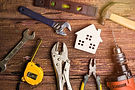 Construction and home repair tools on wooden work bench